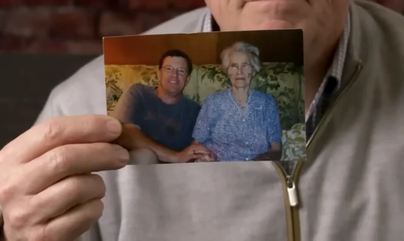 Dennis with photo of his mother